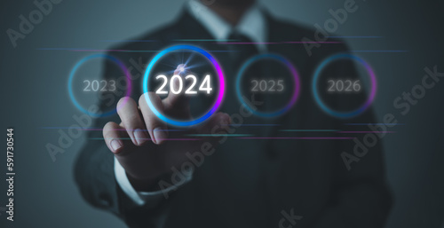 Hand Touching New Goals and Plans on Virtual Screen 2024 and numbers for Next Year Technology Concept