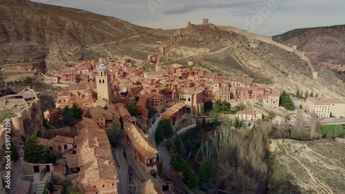 4K drone over Albarracin beautiful Spanish countryside town with historic defense wall photo