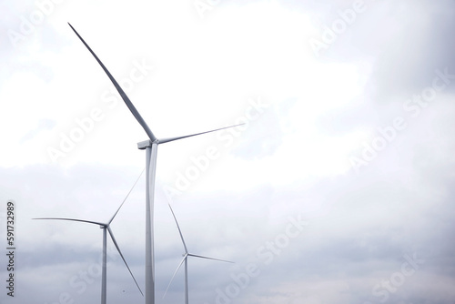 Fotografi Windmills in the background of cloudy sky
