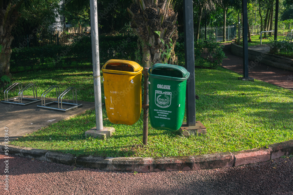 Multi colors recycle bin garbage in public park to save environment care and reduce trash. Make Earth more clean and reduce junk. Helping the environment Multi colors recycle bin garbage in public park to save environment care and reduce trash. Make Earth more clean and reduce junk. Helping the environment