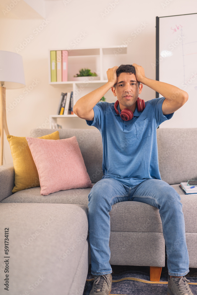 Vertical photo of a desperate casual businessman sitting at home Vertical photo of a desperate casual businessman sitting at home