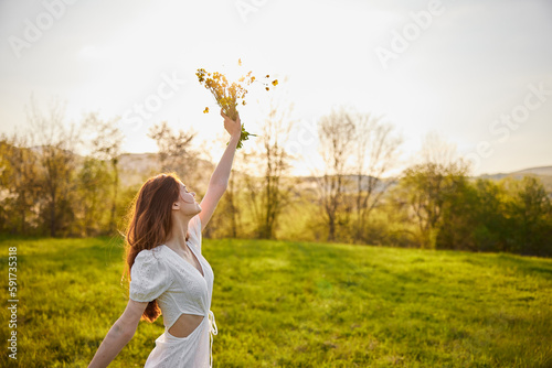 joyful girl at yellow rape seed meadow on sun set