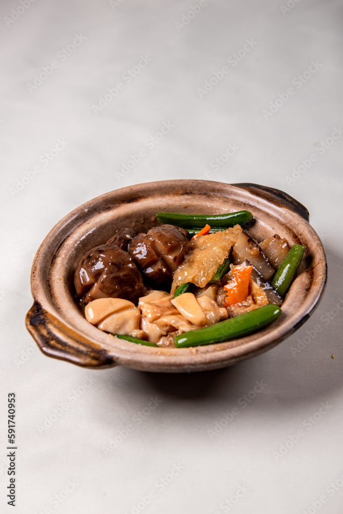 braised assorted dried seafood sea cucumber mushroom bean curd skin and broccoli mixed vegetables in sauce casserole on wood table asian chinese halal food banquet menu for restaurant braised assorted dried seafood sea cucumber mushroom bean curd skin and broccoli mixed vegetables in sauce casserole on wood table asian chinese halal food banquet menu for restaurant