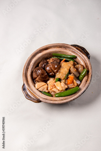 braised assorted dried seafood sea cucumber mushroom bean curd skin and broccoli mixed vegetables in sauce casserole on wood table asian chinese halal food banquet menu for restaurant