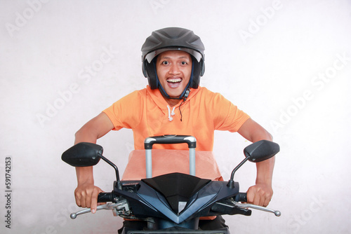 front view of adult asian man driving motorbike with helmet smiling happy, motorbike riding concept, isolated on white