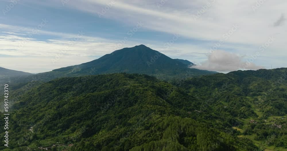 Mountain slopes covered with rainforest and jungle view from above. Sumatra. Indonesia. Mountain slopes covered with rainforest and jungle view from above. Sumatra. Indonesia.
