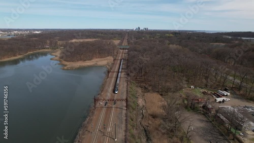 Wallpaper Mural An aerial view of a train traveling off into the distance in the Bronx, New York on a sunny morning. The drone camera dolly in behind the train as it goes further away. Torontodigital.ca