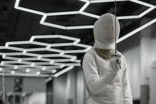 Sword sport athlete portrait wearing protective clothes and helmet at training photo