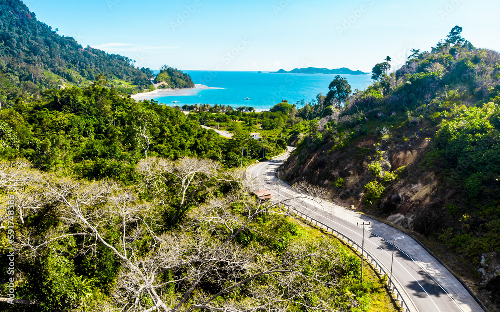Aerial shot of coastal landscape with sea, road and hills Aerial shot of coastal landscape with sea, road and hills