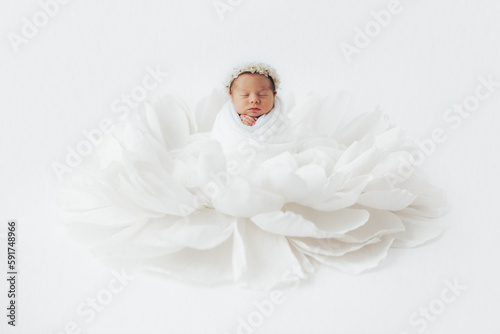 Baby girl asleep in flower