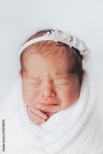 Newborn baby girl wrapped, in studio