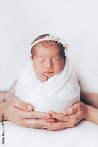 Newborn baby girl wrapped, in studio