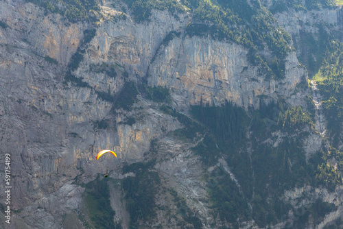 Paragliding in the Swiss Alps as captured from the town of Murren, nestled below the Schilthorn mountain peak