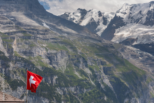 Swiss flag in the mountain village of Murren, a traditional Walser mountain village in the Bernese Highlands of Switzerland, halfway up the Schilthorn Mountain.