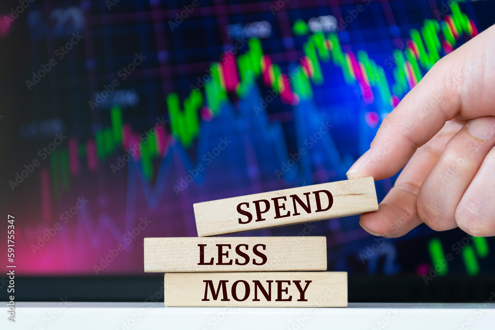 Naklejka premium Wooden blocks with words 'Spend Less Money'. Business concept