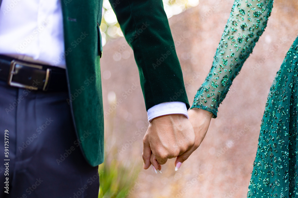 Afghani couple's holding hands close up