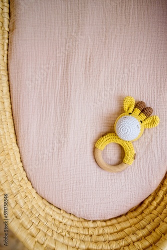 in a basket natural wooden knitted toys for a newborn. View from above