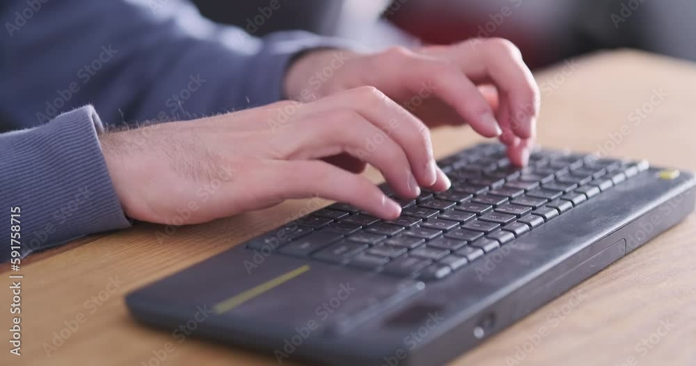 Male fingers fast typing on wireless computer keyboard, side view. Unrecognizable, abstraction, close-up. Concept of the work of a hacker, programmer, copywriter. Male fingers fast typing on wireless computer keyboard, side view. Unrecognizable, abstraction, close-up. Concept of the work of a hacker, programmer, copywriter.