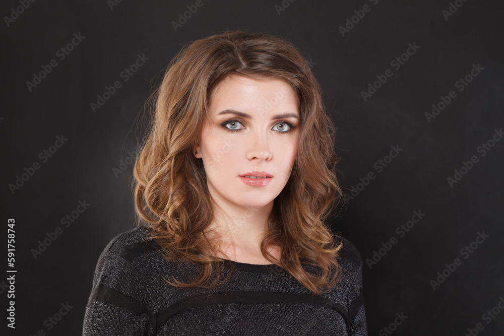 Portrait of nice elegant woman with brown wavy hair and makeup on black background Portrait of nice elegant woman with brown wavy hair and makeup on black background