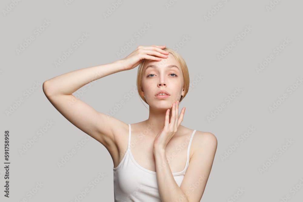 Beautiful woman touching her hands her face. Perfect female face. Facial treatment, skincare and cosmetology concept Beautiful woman touching her hands her face. Perfect female face. Facial treatment, skincare and cosmetology concept