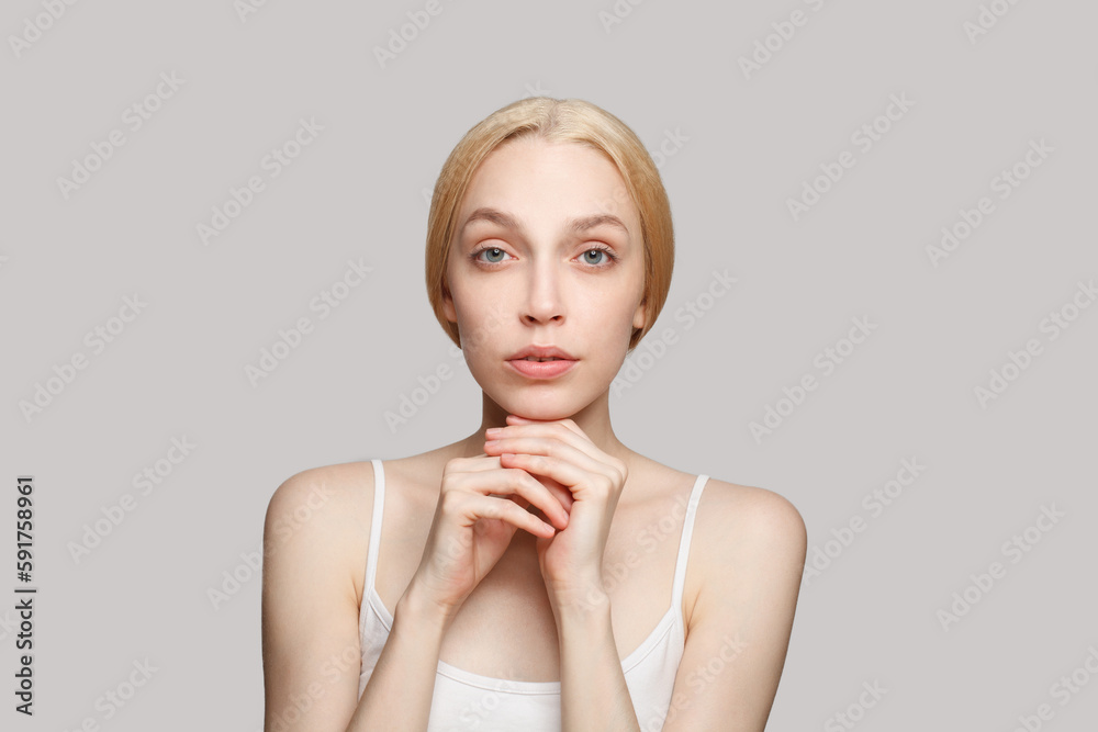 Young female face. Blonde woman with clear skin. Facial treatment, skincare and cosmetology concept