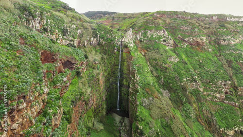 Waterfall plunges into the gorge at the Miradouro da Garganta Funda viewpoint on the island of Madeira in Portugal