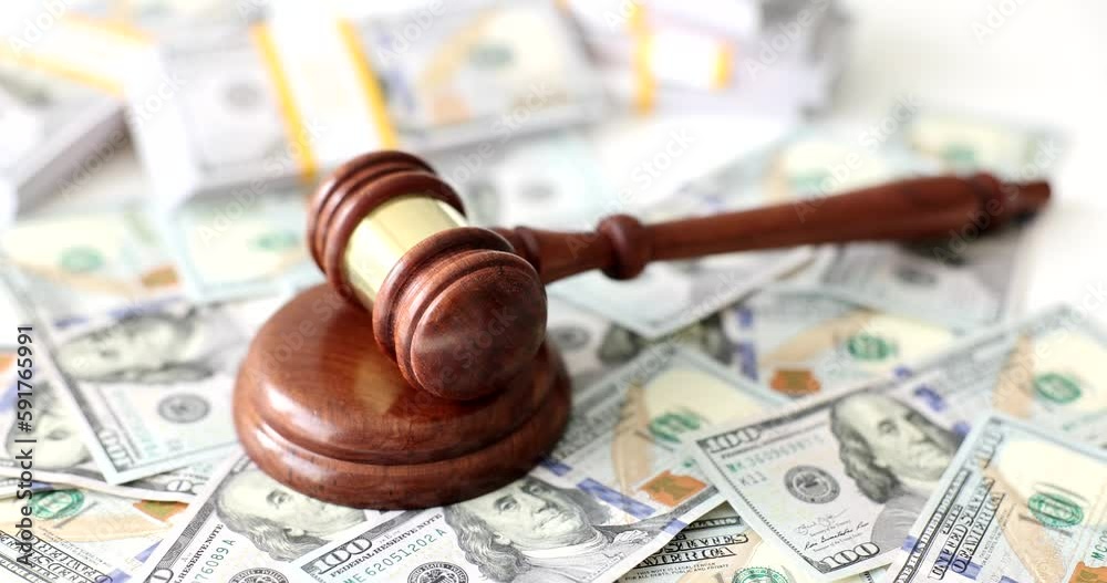 Judge gavel and wooden sound block lie on heap of dollar banknotes. Concept of financial judgment in court. Hammer and scattered money cash Judge gavel and wooden sound block lie on heap of dollar banknotes. Concept of financial judgment in court. Hammer and scattered money cash