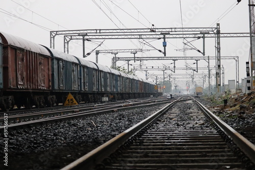 the indian goods train moving on railway track with empty sky