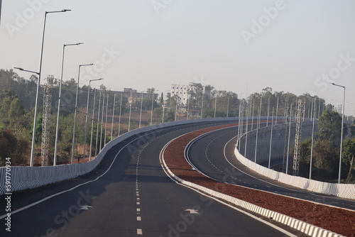 the empty highway road in india with no people and no vehicles with street lights