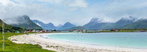 Summer cloudy view of the beach with white sand in Ramberg (Norway, Lofoten). People unrecognizable.