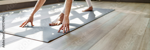 Fitness woman doing yoga exercise stretching on mat yoga, wellbeing lifestyle.