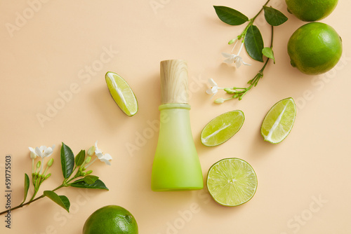 Flower branches with Limes and Lime slices are displayed with an unlabeled jar. The citric acid of Lime  Citrus aurantiifolia  gradually fades spots and evens out skin tone