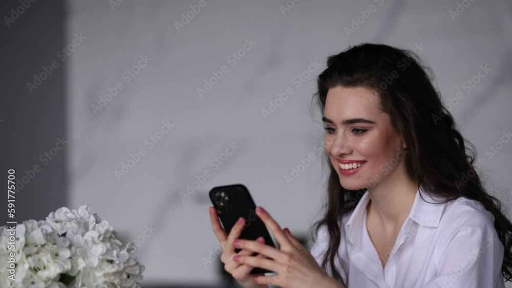 Young woman use phone sit in the kitchen Young woman use phone sit in the kitchen