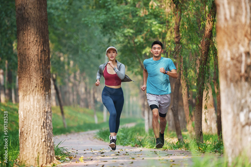 Young couples to running in the woods