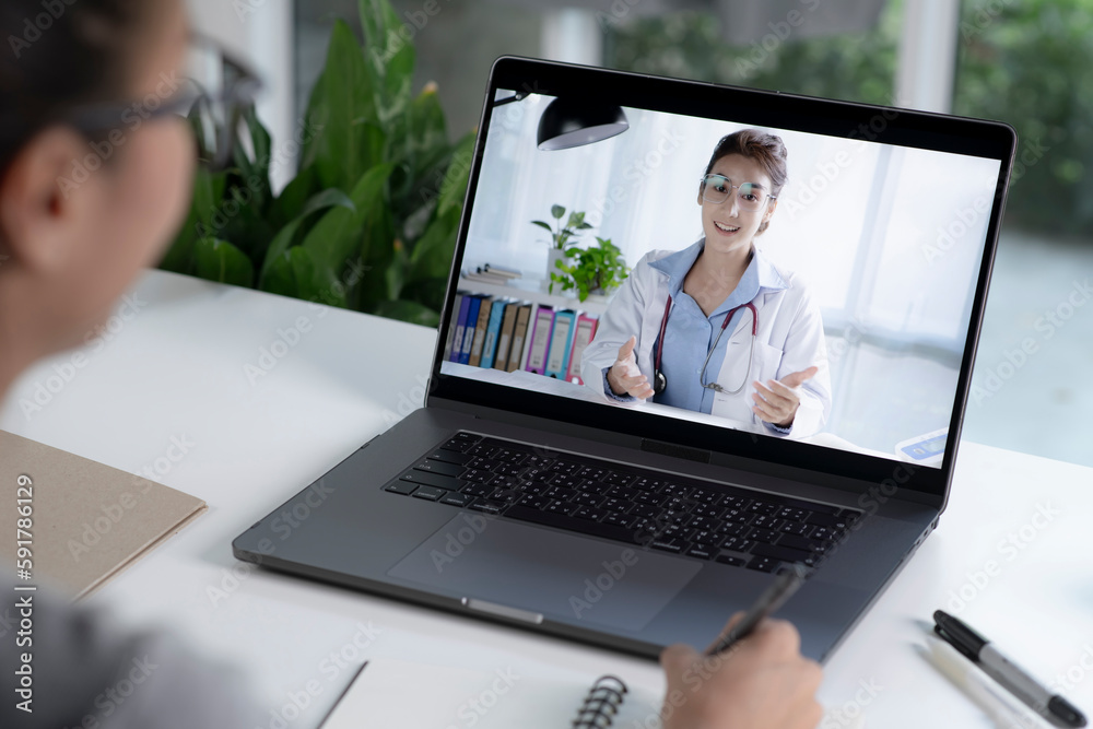 Young Asian woman have video call with doctor at home. Female patient talk consult with physician online on webcam conference on computer. Young Asian woman have video call with doctor at home. Female patient talk consult with physician online on webcam conference on computer.