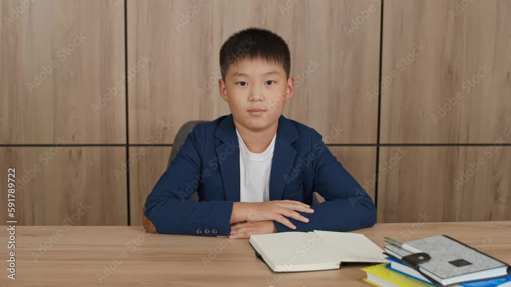 Distance learning, asian teen boy sitting at the desk in living room and study at home, homeschooling online by video call. Distance learning, asian teen boy sitting at the desk in living room and study at home, homeschooling online by video call.