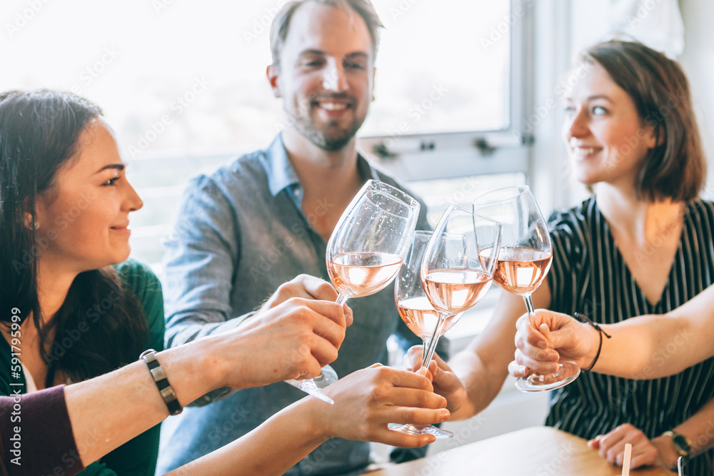 view of glasses clinking during a toast among happy people view of glasses clinking during a toast among happy people