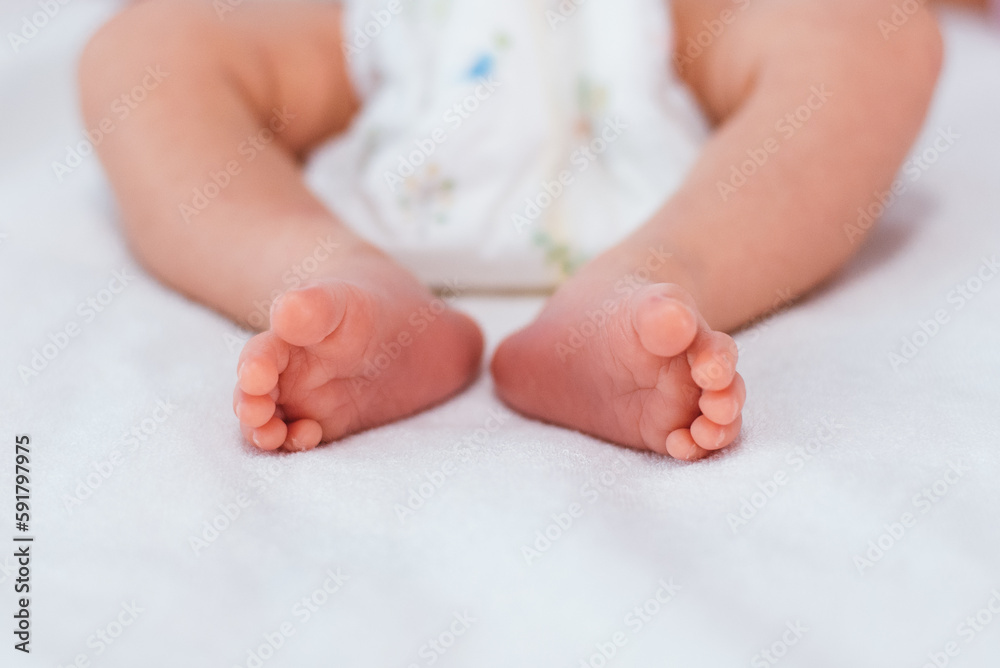 Newborn baby feet on white blanket. Cmaternity and babyhood concept. Newborn baby feet on white blanket. Cmaternity and babyhood concept.