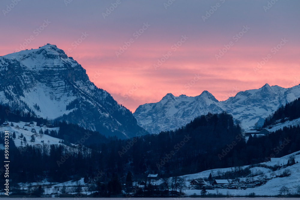 Pink sunset sky Alps Switzerland
