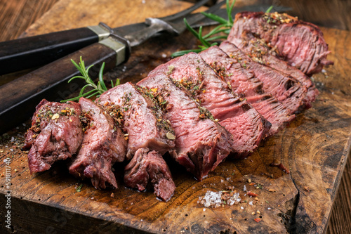 Billede på lærred Barbecue dry aged entrecote beef steak sliced and served as close-up on a rustic