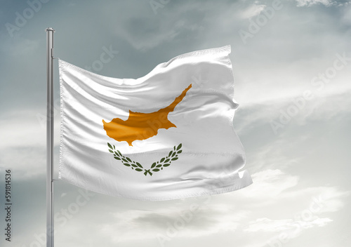 Cyprus national flag cloth fabric waving on beautiful sky Background.