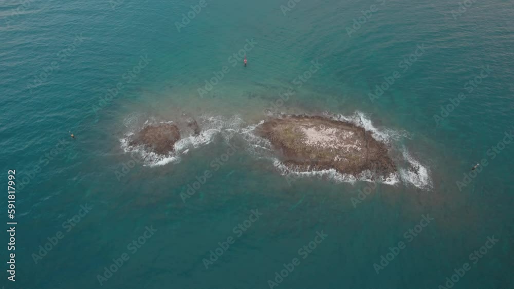 Top view of a small island and people in a beautiful tranquil water Top view of a small island and people in a beautiful tranquil water