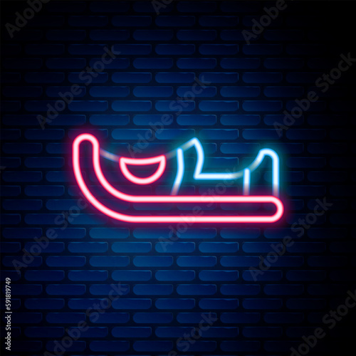 Glowing neon line Traditional indian shoes icon isolated on brick wall background. Colorful outline concept. Vector