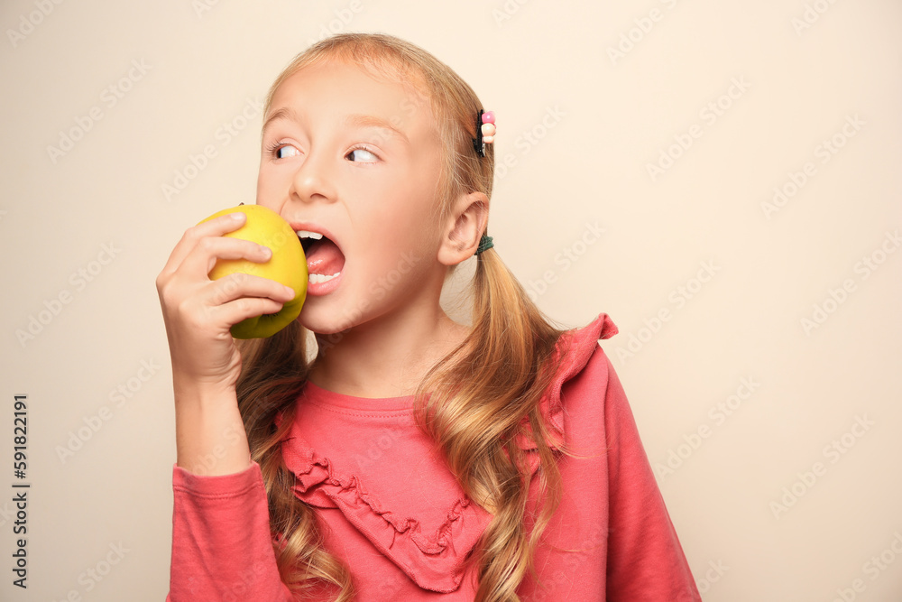 Cute little girl with apple on light background Cute little girl with apple on light background