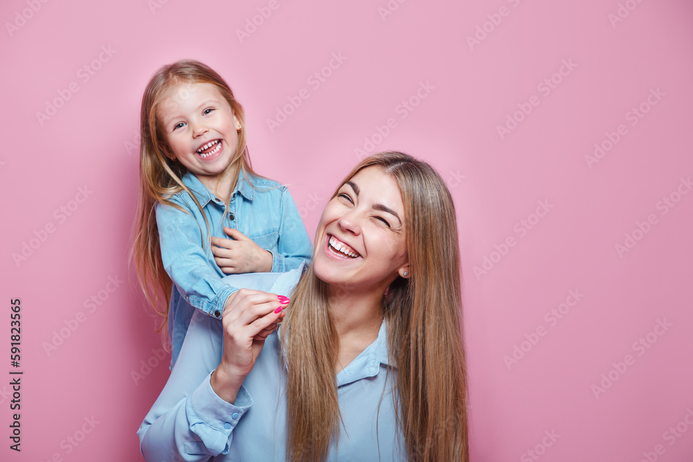 Happy family. Little child baby girl 5-6 years old hugs her mom and laughs Happy family. Little child baby girl 5-6 years old hugs her mom and laughs