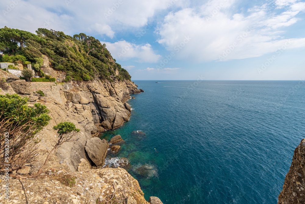 Rocky coast and Mediterranean Sea (Ligurian Sea) of Portofino village. Tourist resort in Genoa Province (Genova), Liguria, Italy, Europe.