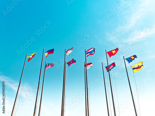 Low Angle View of Waving Flags of ASEAN Countries Against Blue Sky
