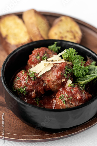 italian traditional beef meatballs with tomato sauce on wood board