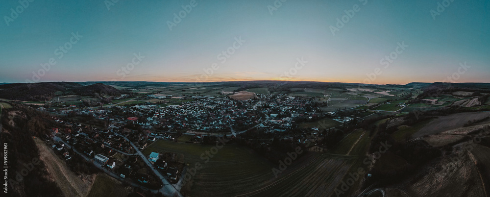 Aerial panoramic view of buildings in a town during sunrise