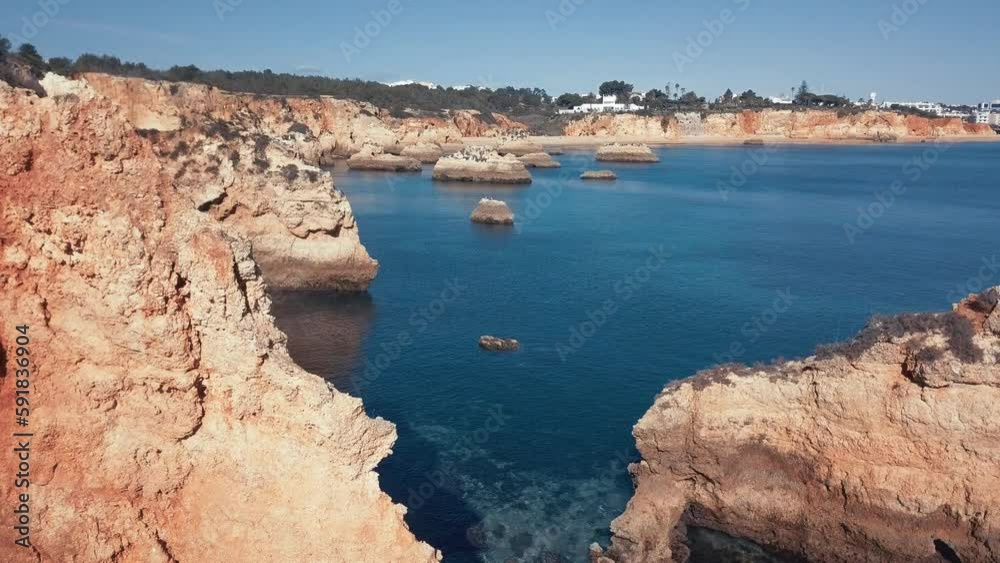 Drone view of cliffs in the sea in the daytime Drone view of cliffs in the sea in the daytime